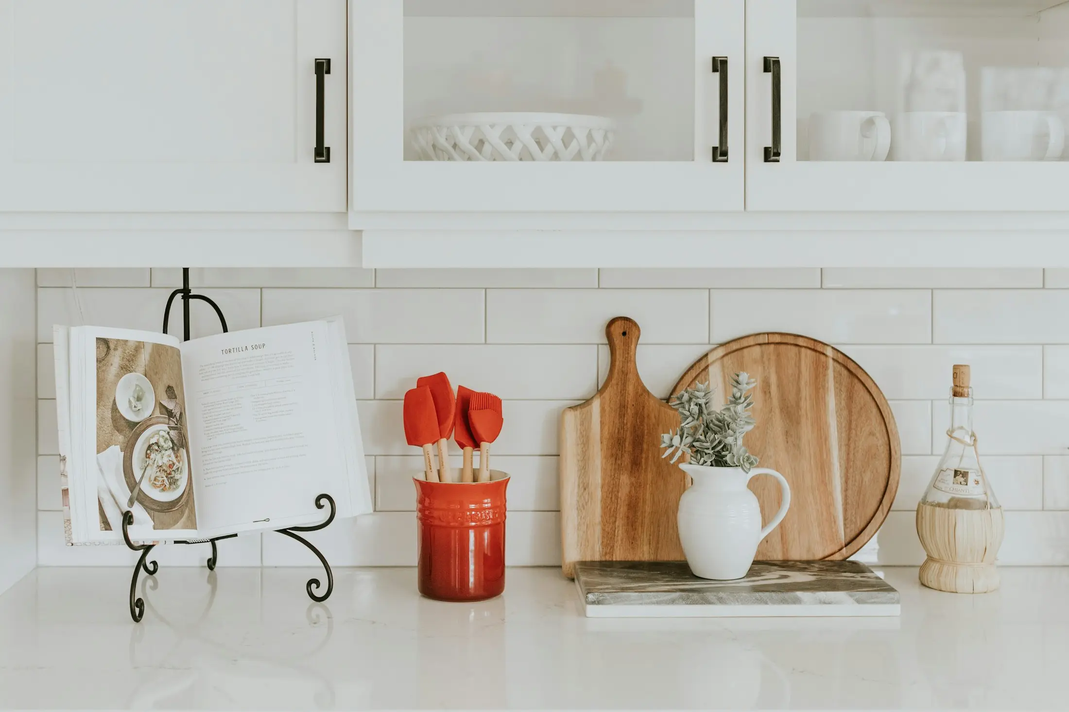 Clean kitchen worktop with neatly arranged tableware and dining items